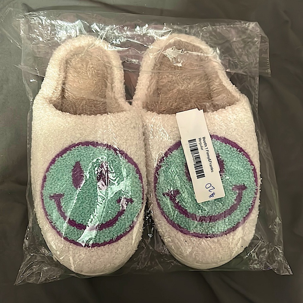 White house shoes with a blue smiley face and a purple outline.